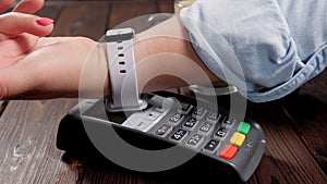 Customer using smart watch to pay.