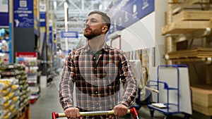 Customer walking with shopping cart in hardware store