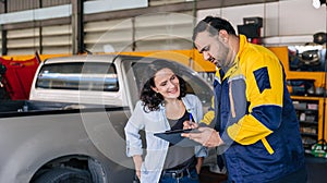 Customer women happy enjoy with mechanic worker car service check list in auto center workshop