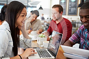 Customers In Busy Coffee Shop