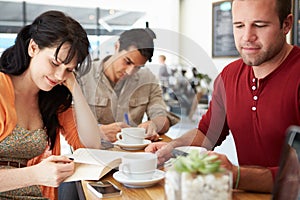 Customers In Busy Coffee Shop