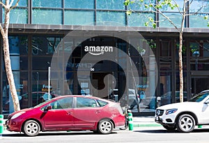 Customers cars parked in front of Amazon Hub Locker location