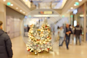 Customers in Christmassy Decorated Shopping Center Blurred Scene
