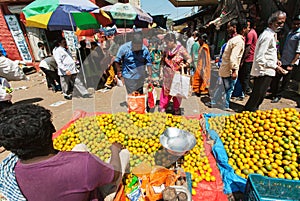 Customers of city market buying oranges and lemons at farmer marketplace