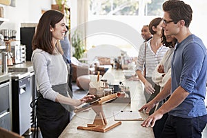 Customers at a coffee shop queuing to order and pay