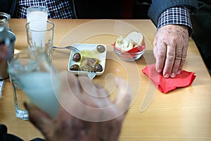 Customers drinking ouzo in Larissa, Greece.