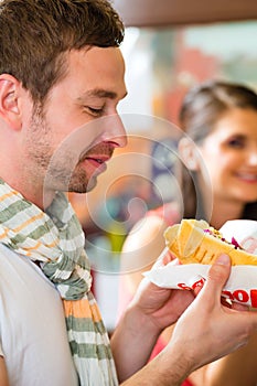 Customers eating Hotdog in fast food snack bar