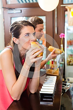 Customers eating Hotdog in fast food snack bar