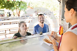 Customers ordering from food truck