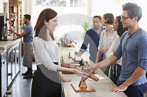 Customers queuing to order and pay at a coffee shop