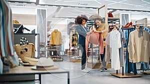 Customers Shopping in Modern Clothing Store, Retail Sales Associate Assists Client. Diverse People