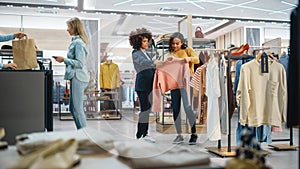 Customers Shopping in Modern Clothing Store, Retail Sales Associate Assists Client. Diverse People