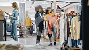 Customers Shopping in Modern Clothing Store, Retail Sales Associate Assists Client. Diverse People