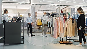 Customers Shopping in Modern Clothing Store, Retail Sales Associate Assists Clients. Diverse People