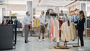 Customers Shopping in Modern Clothing Store, Retail Sales Associate Assists Clients. Diverse People