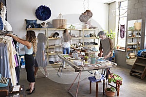 Customers and staff in a busy clothes shop