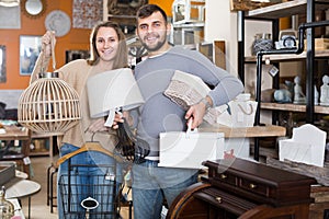 customers standing with purchases in furnishings store