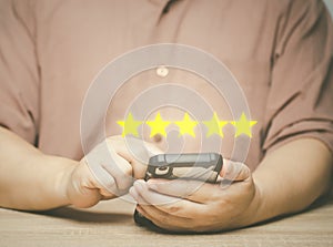 Customers using mobile phones rate their 5 stars satisfaction with the service through the application. satisfaction survey