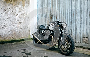 Customized motorcycle in front of garage door