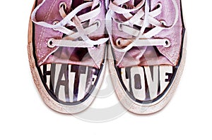 Customized used pink sneakers with words hate and love photo
