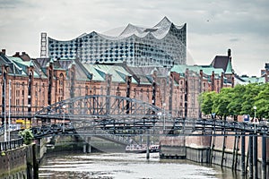Customs channel in the old warehouse district Speicherstadt in Hamburg, Germany with Elbphilharmonie concert hall in