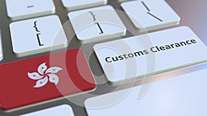 CUSTOMS CLEARANCE text and flag of Hong Kong on the buttons on the computer keyboard. Import or export related