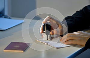 Customs Officer Stamping a Passport