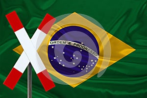 Customs sign, stop, attention against the background of the silk national flag of Brazil, the concept of border and customs