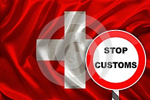 Customs sign, stop, attention against the background of the silk national flag of Switzerland, the concept of border and customs