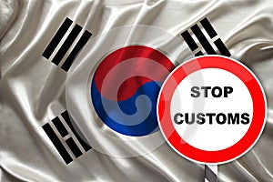 Customs sign, stop, attention on the background of the silk national flag of South korea, the concept of border and customs