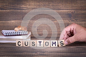 Customs. wooden letters on the office desk