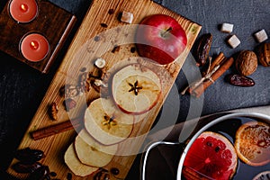 A cut apple with dates, nuts on a wooden dostichke. View from above