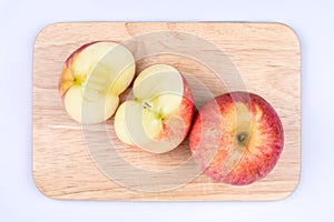 Cut an apple in half and place it on a cutting board  on a white background, Sweet and juicy fruit