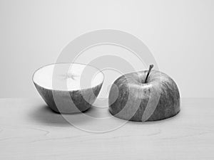Cut apple, top and bottom half, side by side