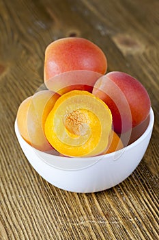cut apricots in a glass white bowl