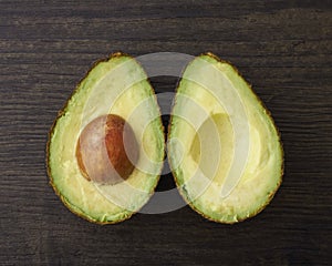 Cut Avocado halves with seed photo