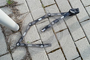 Cut bicycle lock by thieves with bolt cutter after stealing a bike near the parking lot, details, closeup