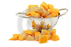 Cut butternut pumpkin blocks in a metal colander