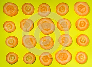 cut carrot on a yellow background. Background of carrot slices. Vegetarian food. Vitamins. Fresh vegetables on the table