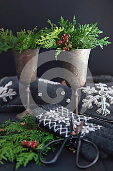 Cut cedar in old wine goblets for holiday decoration