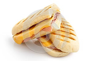 Cut cheese and ham toasted panini melt. Isolated on white.
