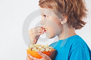 Cut child eating popcorn