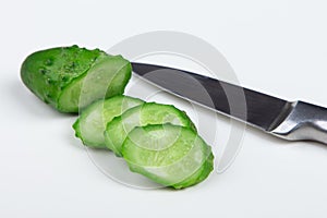 The cut cucumber with the knife