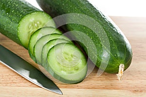 Cut cucumbers and knife photo