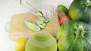 Cut fresh cucumber on a wooden cutting Board.Kitchen table with vegetables.