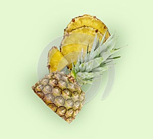 Cut fresh juicy pineapple on pale green background, top view