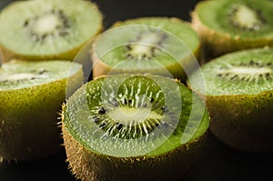 cut fresh  kiwi against black background/cut fresh kiwi against black background. Close up