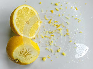 Cut fresh Lemon and peel seen on a dish, ready for a baking ingredient.