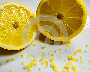 Cut fresh Lemon and peel seen on a dish, ready for a baking ingredient.