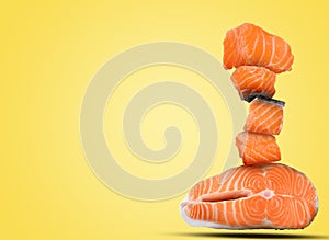 Cut fresh salmon falling on yellow background, space for text